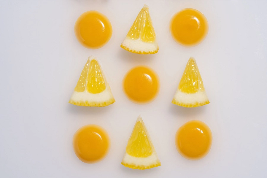 round yellow gummies and slices of lemons